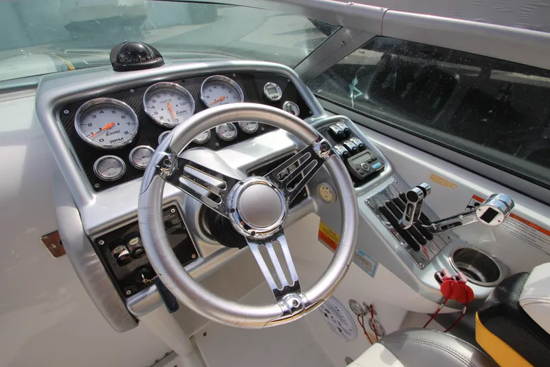Slide: The Image of 2008 Formula 292 FASTech boat dashboard with steering wheel and control gauges. - 16