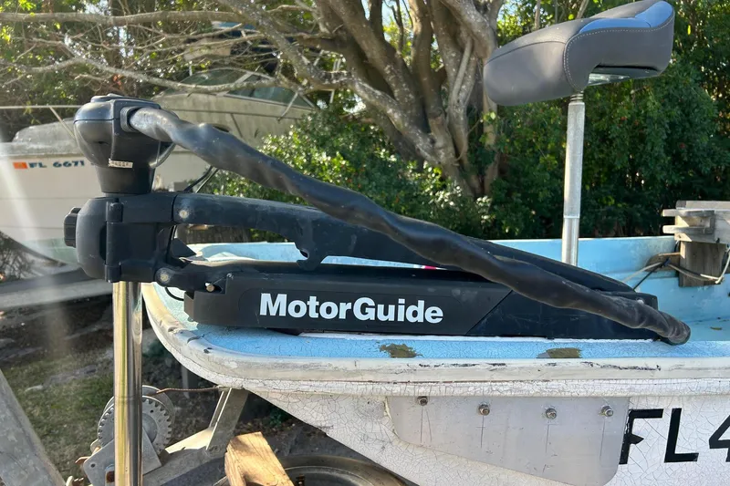 Slide: The Image of 1969 Boston Whaler 13 Sport with MotorGuide trolling motor, parked outdoors. - 14