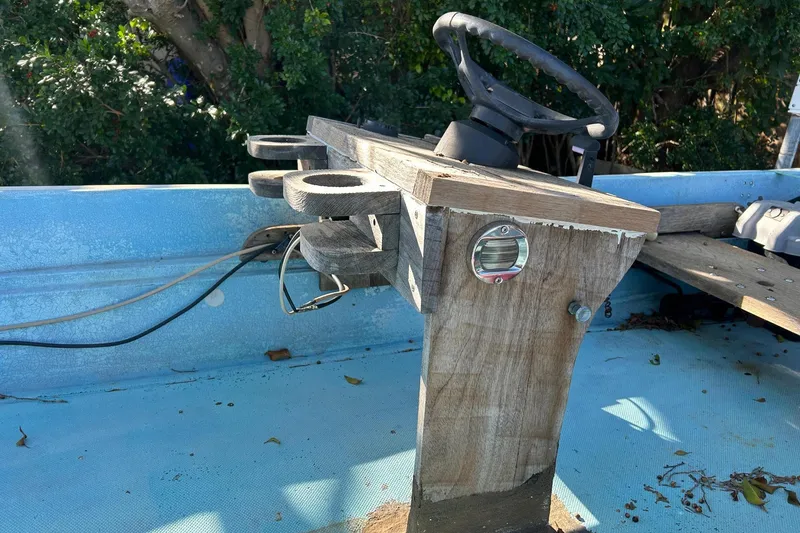 Slide: The Image of 1969 Boston Whaler 13 Sport boat interior with wooden steering console and blue deck. - 15