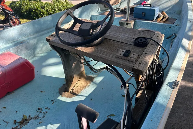 Slide: The Image of 1969 Boston Whaler 13 Sport boat interior with steering wheel and equipment. - 4