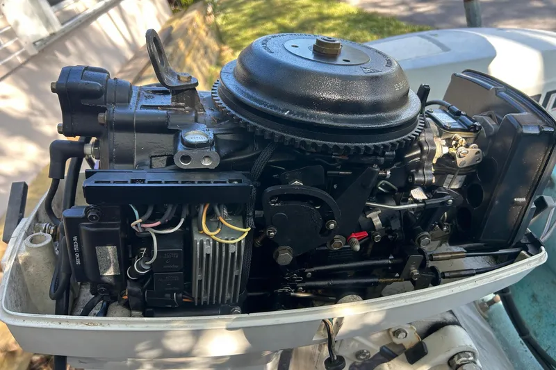Slide: The Image of Close-up of a 1969 Boston Whaler 13 Sport boat engine, showcasing mechanical components. - 5