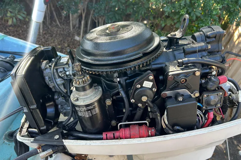 Slide: The Image of Close-up of a 1969 Boston Whaler 13 Sport boat engine, showcasing intricate mechanical details. - 6