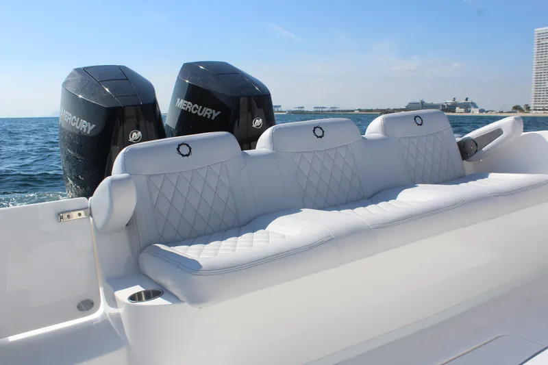 Slide: The Image of 2025 Fountain 34 Center Console boat with Mercury engines, featuring luxurious white seating. - 9