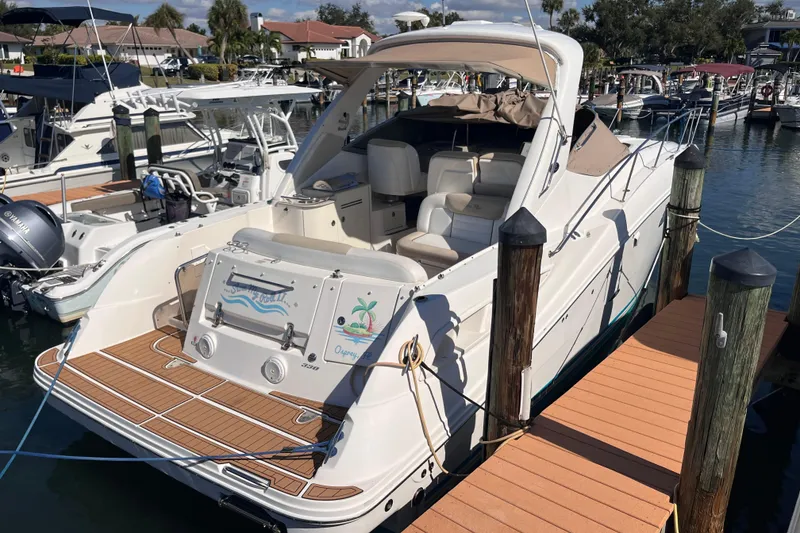 Slide: The Image of 2008 Sea Ray 330 Sundancer docked at marina, featuring sleek design and spacious deck. - 1