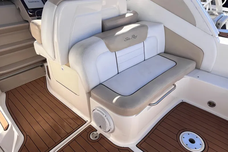 Slide: The Image of 2008 Sea Ray 330 Sundancer interior with beige seating and wood-style flooring. - 10