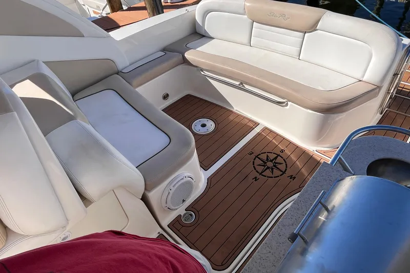 Slide: The Image of Interior of 2008 Sea Ray 330 Sundancer with cushioned seating and compass design on deck. - 12