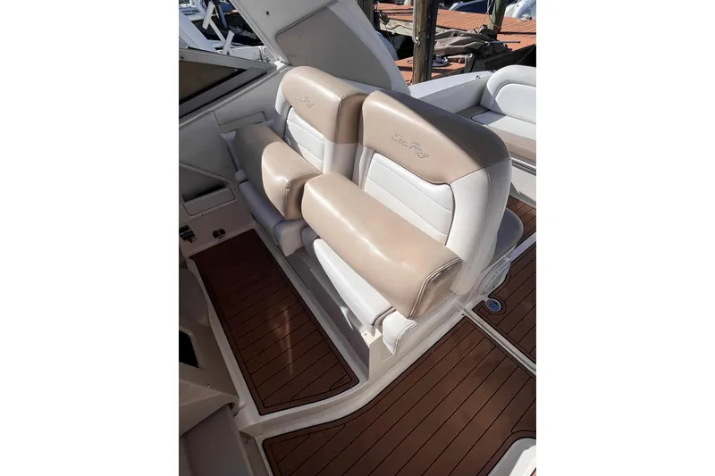 Slide: The Image of 2008 Sea Ray 330 Sundancer cockpit with beige and white seating on teak flooring. - 13