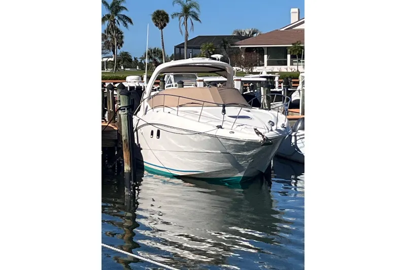 Slide: The Image of 2008 Sea Ray 330 Sundancer docked at marina with palm trees in background. - 2