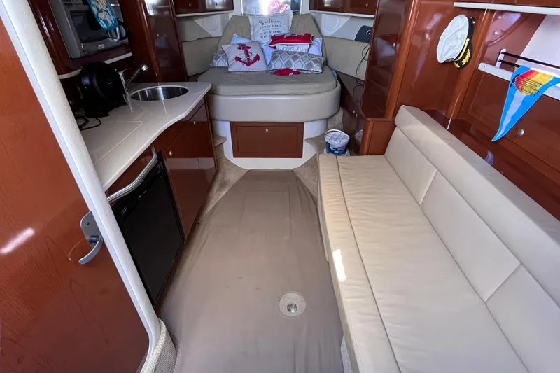 Slide: The Image of Interior of 2008 Sea Ray 330 Sundancer yacht with kitchenette and seating area. - 22