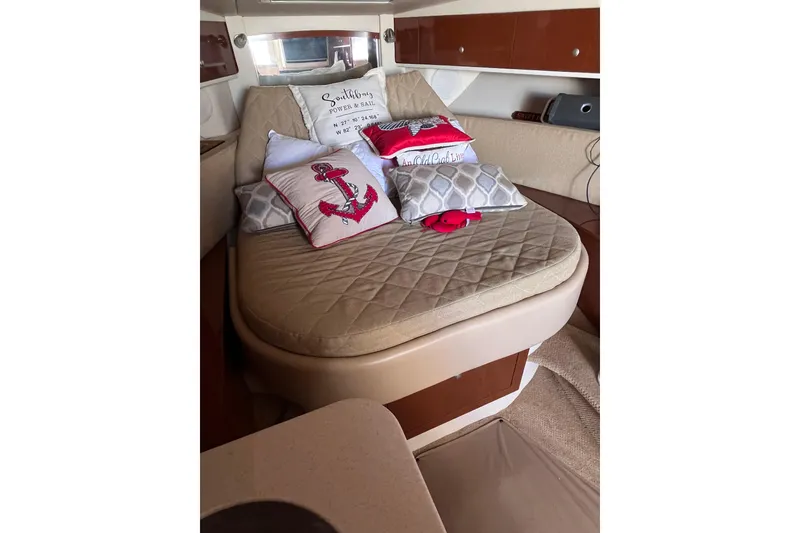 Slide: The Image of Interior of 2008 Sea Ray 330 Sundancer with cozy bed and nautical-themed pillows. - 23