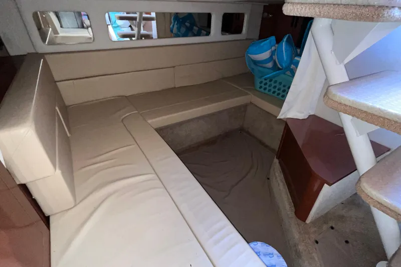 Slide: The Image of Interior cabin of 2008 Sea Ray 330 Sundancer with beige seating and stairs. - 25