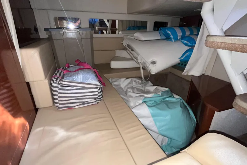Slide: The Image of Interior cabin of 2008 Sea Ray 330 Sundancer with striped bag and bedding. - 34