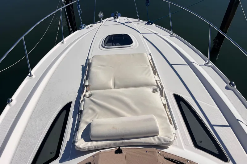 Slide: The Image of 2008 Sea Ray 330 Sundancer boat deck with cushioned sunbed and sleek design. - 38