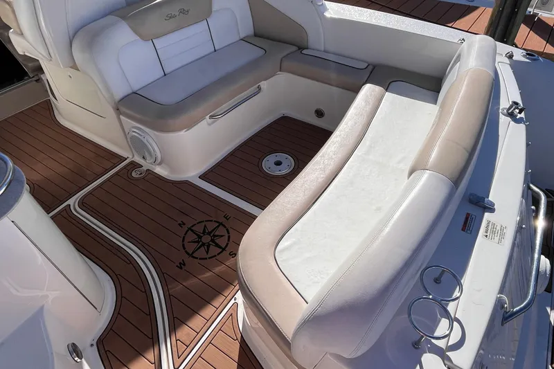 Slide: The Image of 2008 Sea Ray 330 Sundancer interior with cushioned seating and compass rose design on deck. - 8