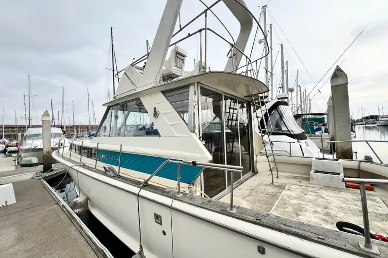Slide: The Image of 1967 Chris-Craft 38 Constellation docked at a marina, showcasing classic design. - 10
