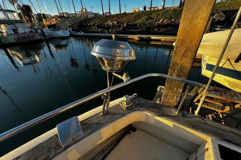 Slide: The Image of 1967 Chris-Craft 38 Constellation docked, featuring a mounted grill and scenic marina view. - 11