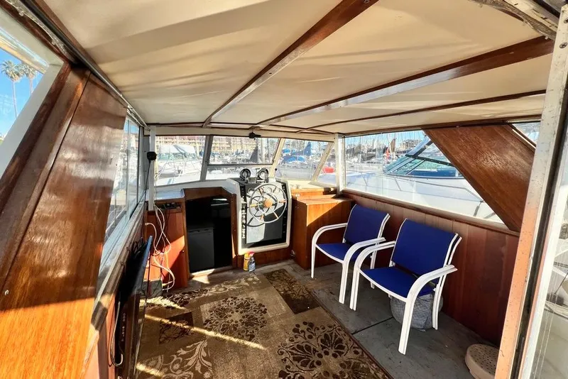 Slide: The Image of 1967 Chris-Craft 38 Constellation interior with helm, blue chairs, and wood paneling. - 15