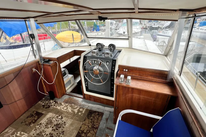 Slide: The Image of 1967 Chris-Craft 38 Constellation boat interior with vintage helm and wooden accents. - 16
