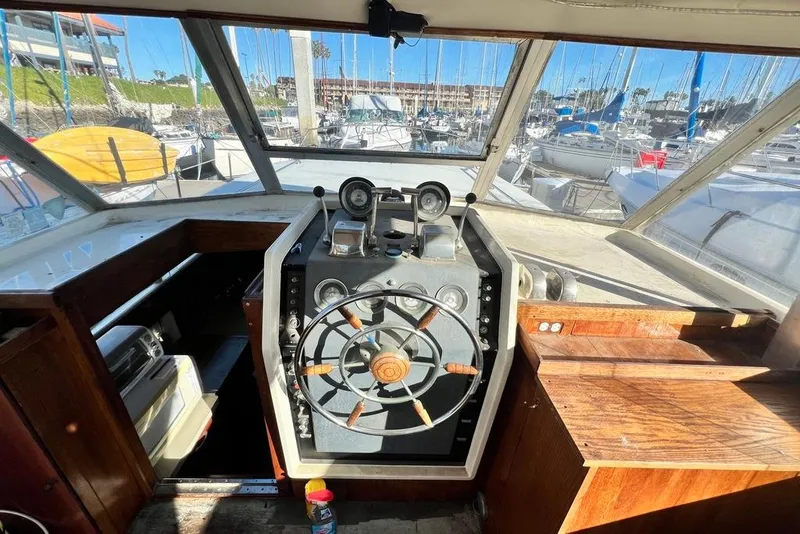 Slide: The Image of 1967 Chris-Craft 38 Constellation helm with wooden steering wheel and marina view. - 18