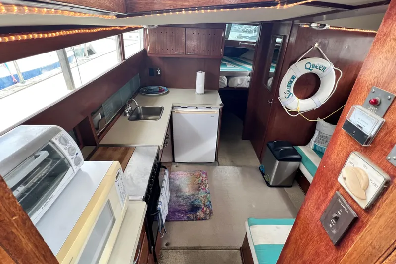 Slide: The Image of Interior of 1967 Chris-Craft 38 Constellation boat with kitchen and seating area. - 20
