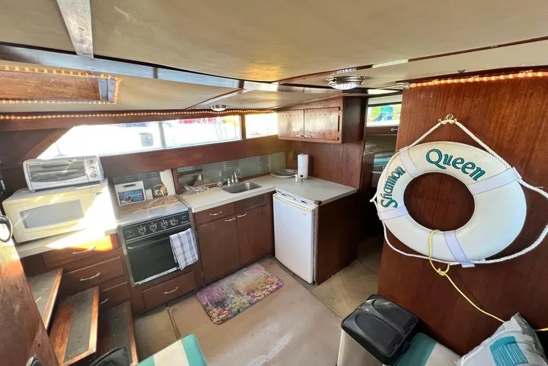 Slide: The Image of 1967 Chris-Craft 38 Constellation interior with kitchen and life preserver. - 23