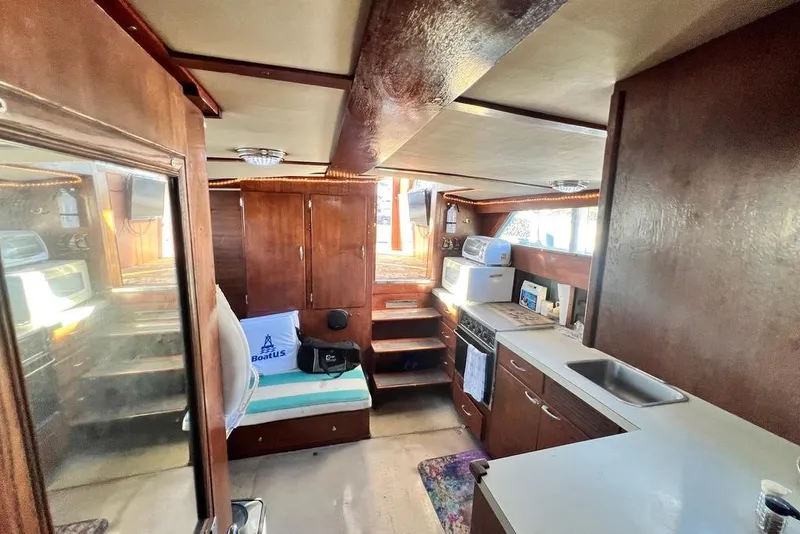 Slide: The Image of Interior of 1967 Chris-Craft 38 Constellation boat with wood paneling and kitchen amenities. - 24