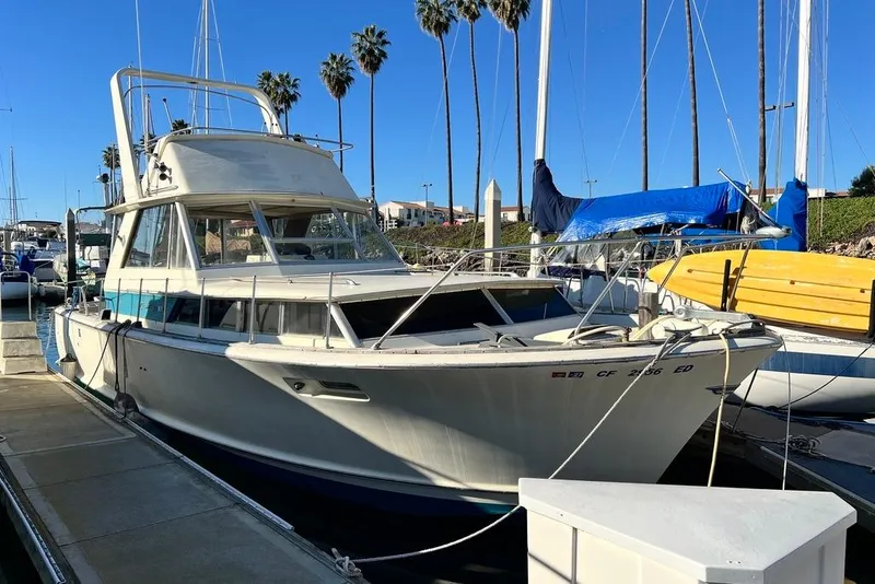 Slide: The Image of 1967 Chris-Craft 38 Constellation docked at marina under clear blue sky. - 3