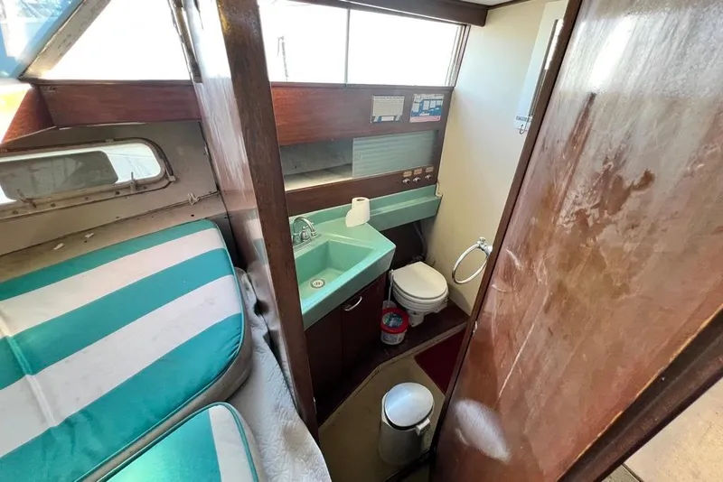 Slide: The Image of 1967 Chris-Craft 38 Constellation interior with bathroom and striped seating. - 32