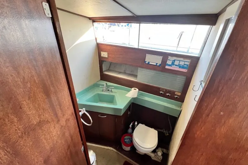 Slide: The Image of 1967 Chris-Craft 38 Constellation bathroom with turquoise sink and wooden accents. - 33