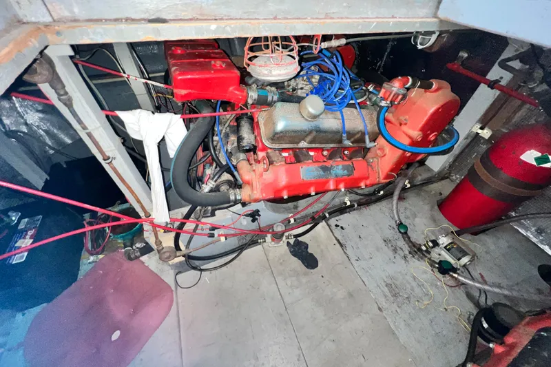 Slide: The Image of Engine compartment of a 1967 Chris-Craft 38 Constellation boat, featuring a red engine. - 42