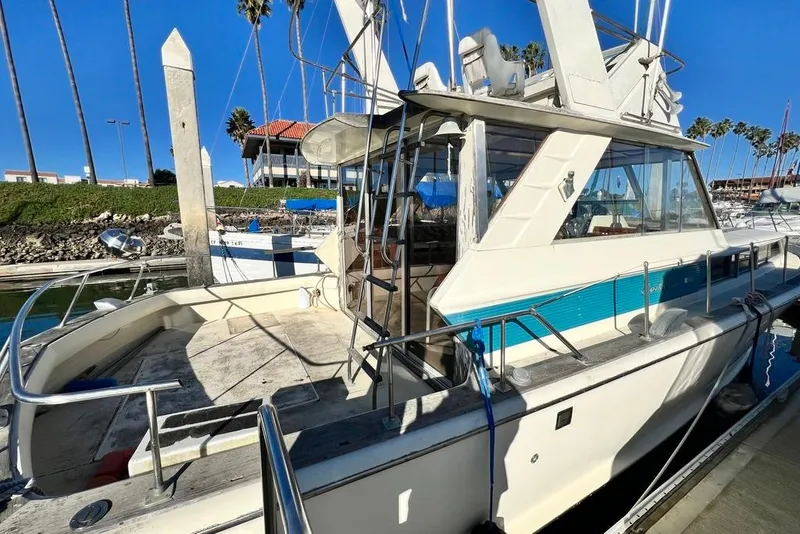 Slide: The Image of 1967 Chris-Craft 38 Constellation yacht docked at marina under clear blue sky. - 9