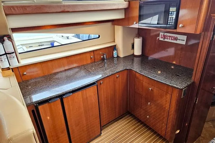 Slide: The Image of Luxurious kitchen area in 2006 Meridian 368 Motoryacht with wood cabinetry and granite countertops. - 12