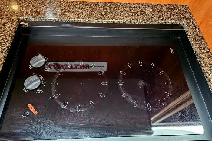 Slide: The Image of Stovetop on 2006 Meridian 368 Motoryacht, featuring a sleek black glass surface. - 14