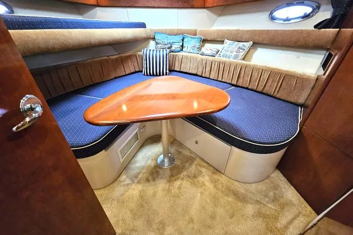 Slide: The Image of 2006 Meridian 368 Motoryacht interior with cozy seating and wooden table. - 16