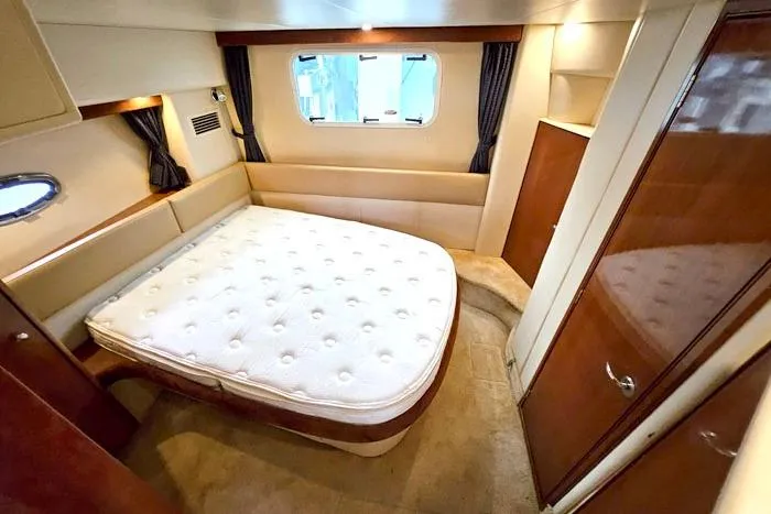 Slide: The Image of Luxurious bedroom interior of 2006 Meridian 368 Motoryacht with cozy bed and elegant wood finishes. - 19
