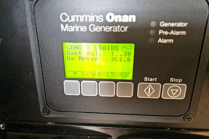 Slide: The Image of Cummins Onan marine generator display on 2006 Meridian 368 Motoryacht, showing battery voltage and hours. - 26