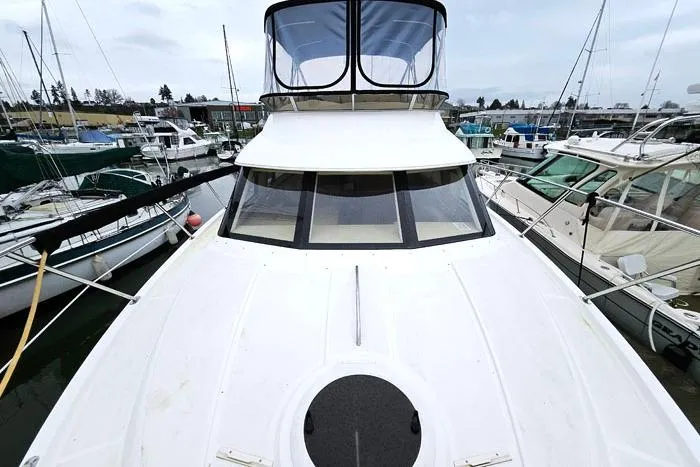 Slide: The Image of 2006 Meridian 368 Motoryacht docked at marina, showcasing sleek design and spacious deck. - 31