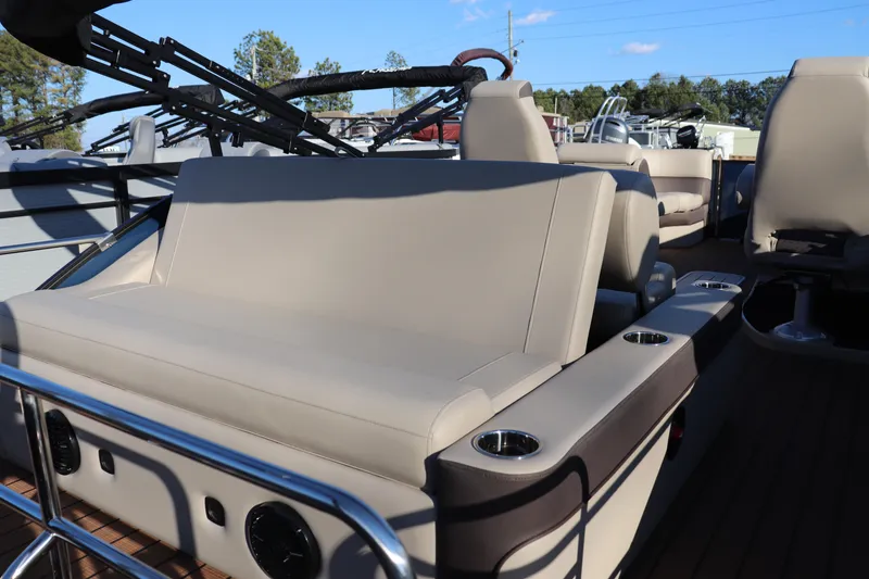 Slide: The Image of 2026 Bentley Pontoons 223 Elite Admiral interior with beige seating and cup holders. - 8