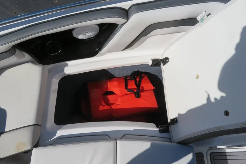 Slide: The Image of 2017 Yamaha Boats AR240 interior seating with speaker, featuring sleek white and gray design. - 18