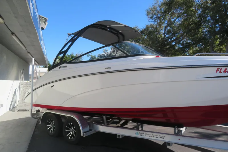 Slide: The Image of 2017 Yamaha Boats AR240 displayed on a trailer outside a marine dealership. - 2