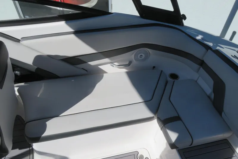 Slide: The Image of 2017 Yamaha Boats AR240 interior with seating and windshield, displayed outdoors. - 21