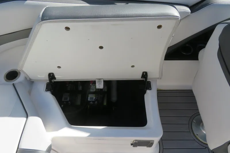 Slide: The Image of 2017 Yamaha AR240 boat storage compartment with non-slip mat and gray deck. - 48