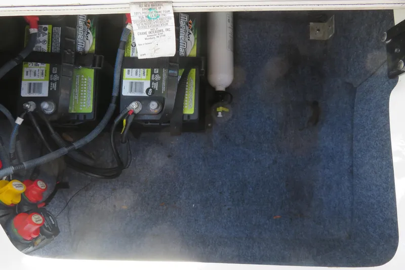 Slide: The Image of 2017 Yamaha AR240 boat compartment with fire extinguisher inside, white panel and handle. - 49