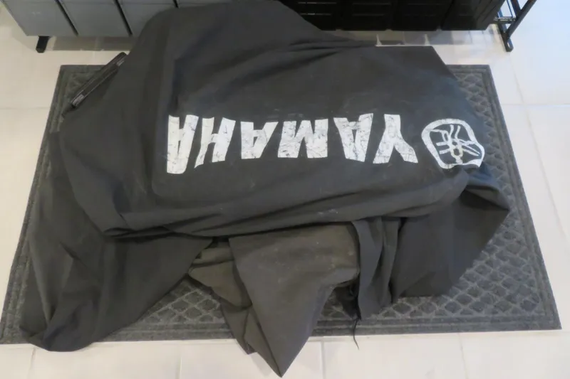 Slide: The Image of Open storage compartment in 2017 Yamaha AR240 boat, revealing a red safety bag. - 54