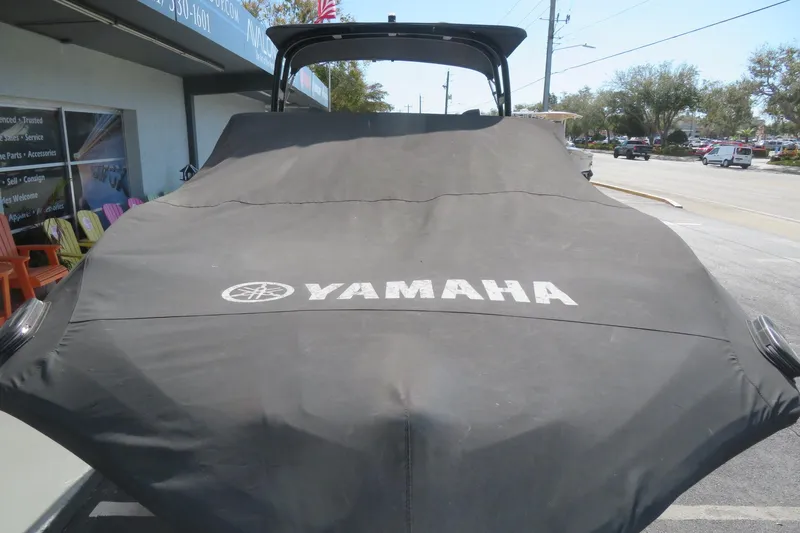 Slide: The Image of 2017 Yamaha AR240 boat covered, parked outside a dealership. - 66