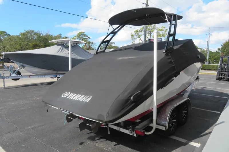 Slide: The Image of 2017 Yamaha AR240 boat covered, parked on a trailer in a lot. - 68