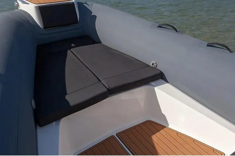 Slide: The Image of Manufacturer Provided Image: 2026 Brig Eagle 8 boat interior with cushioned seating and wooden flooring. - 3