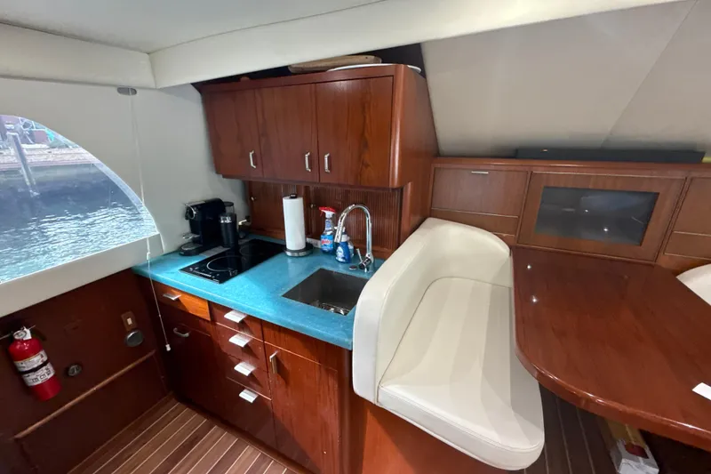 Slide: The Image of Interior of 1992 Ocean Yachts 48 Super Sport with modern kitchen and seating area. - 14