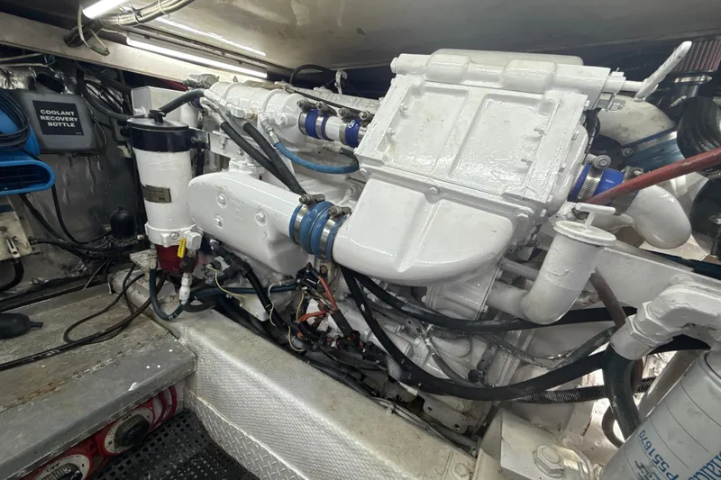 Slide: The Image of Engine room of a 1992 Ocean Yachts 48 Super Sport, showcasing a clean, well-maintained engine. - 34