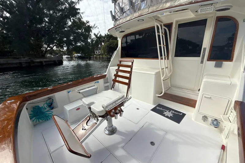 Slide: The Image of 1992 Ocean Yachts 48 Super Sport fishing deck with chair, docked by waterway. - 7